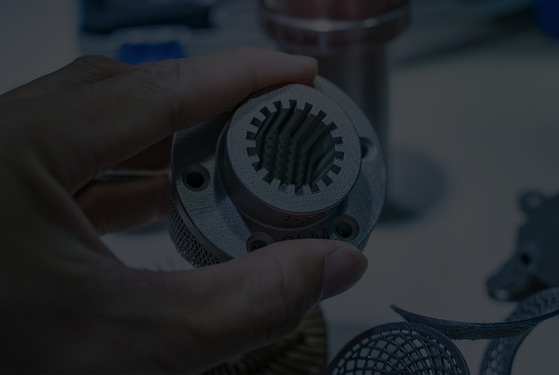 An engineer holding an additively manufactured metal component